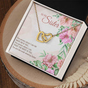 Interlocking Heart Necklace with CZ crystals and floral packaging, perfect gift for sisters.