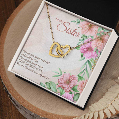 Interlocking Heart Necklace with CZ crystals and floral packaging, perfect gift for sisters.