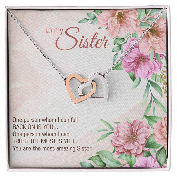 Interlocking Heart Necklace with CZ crystals on floral card for sister's gift.