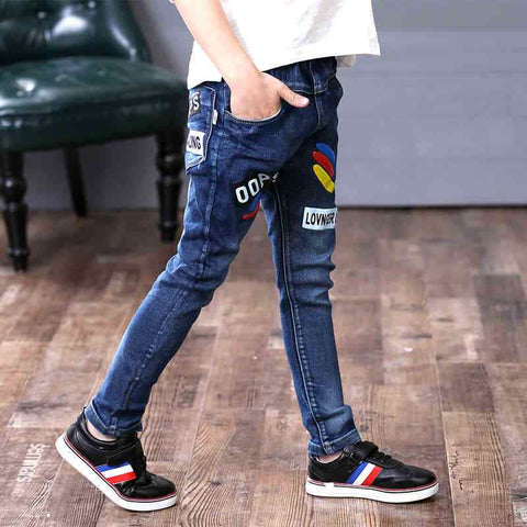 Boys wearing denim jeans with colorful patches, emphasizing style and comfort.