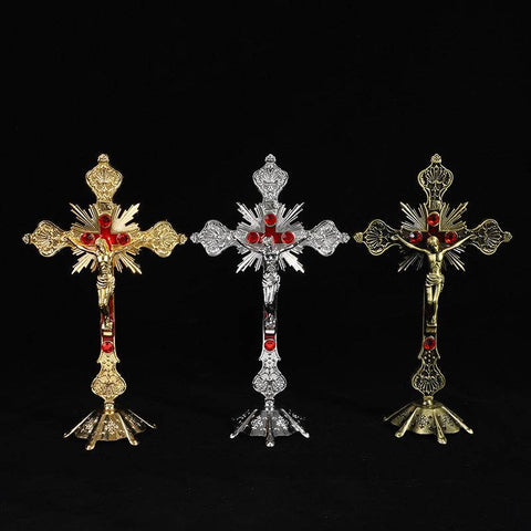 Multicolor religious cross ornaments in gold, silver, and bronze displaying vibrant design and intricate detailing.