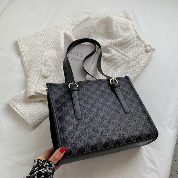 Large Capacity Handbag in black with stylish design and comfortable handles.
