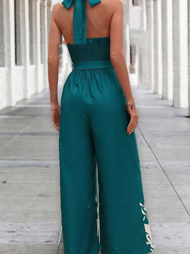 Backless halter jumpsuit in peacock green, featuring a flattering halter neckline and high waist design.