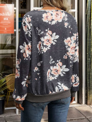 Floral printed V-neck long sleeve sweatshirt with petal sleeves and relaxed fit.
