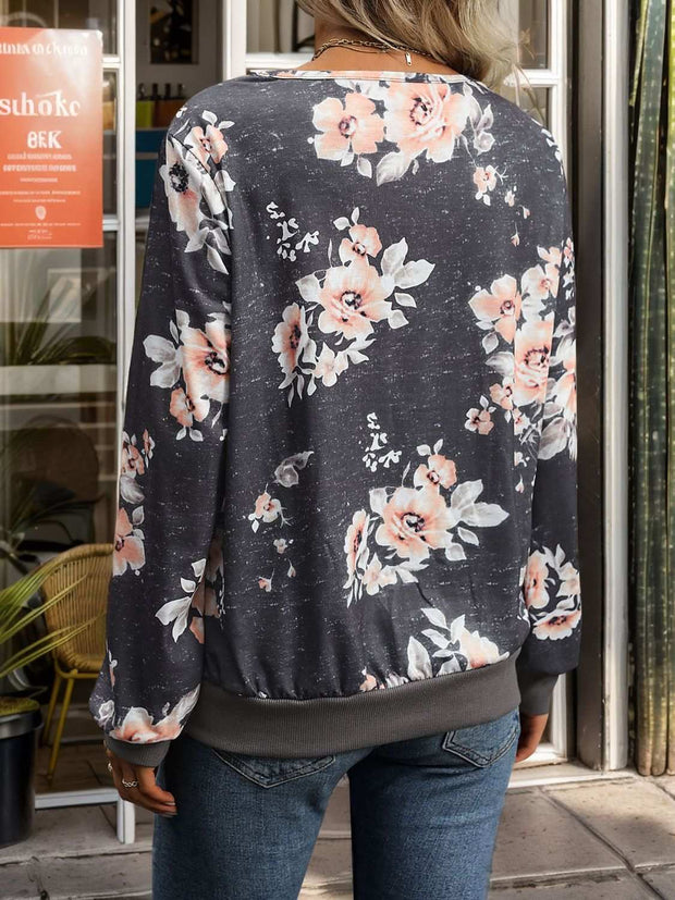 Floral printed V-neck long sleeve sweatshirt with petal sleeves and relaxed fit.