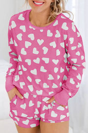 Pink Heart Print Loungewear Set with white heart patterns, featuring a relaxed top and matching shorts.