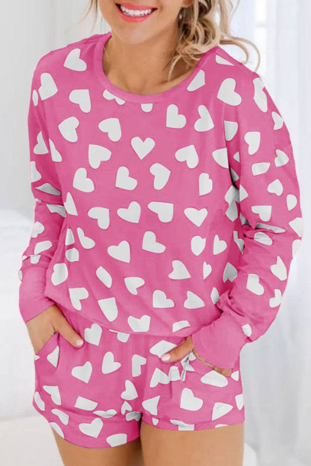 Pink Heart Print Loungewear Set with white heart patterns, featuring a relaxed top and matching shorts.