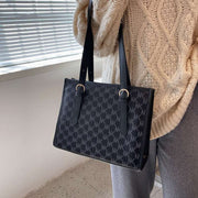 Black large capacity handbag with stylish design and ample storage, perfect for daily use.