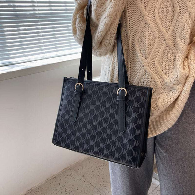 Black large capacity handbag with stylish design and ample storage, perfect for daily use.