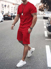 Plus size short sleeve red top and shorts set on a person walking down the street.