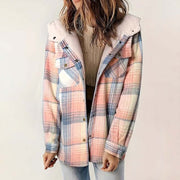 Woman wearing a plaid hooded fleece-lined jacket with soft pastel colors and button pockets