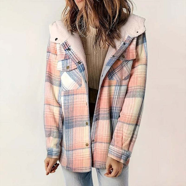 Woman wearing a plaid hooded fleece-lined jacket with soft pastel colors and button pockets