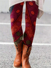 Vibrant printed flared trousers with unique pattern, styled with ankle boots.