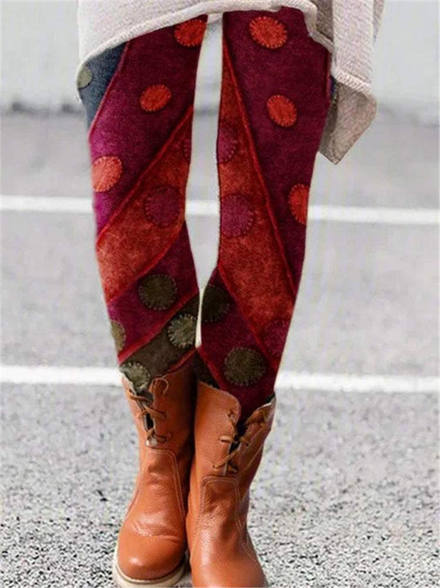 Vibrant printed flared trousers with unique pattern, styled with ankle boots.