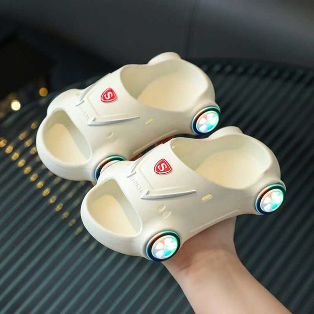 Kids Glowing Slippers with LED lights, comfortable and anti-slip, in white sports car design.