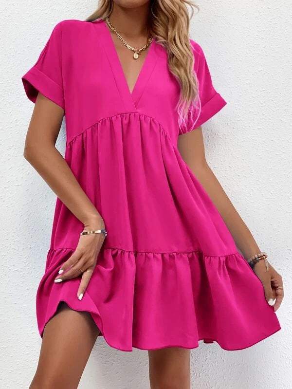 Short-sleeved V-neck dress in vibrant pink with a flowing fit and elegant design.