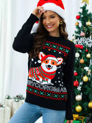 woman wearing black Christmas round neck sweater with festive corgi design and Santa hat standing by decorated Christmas tree