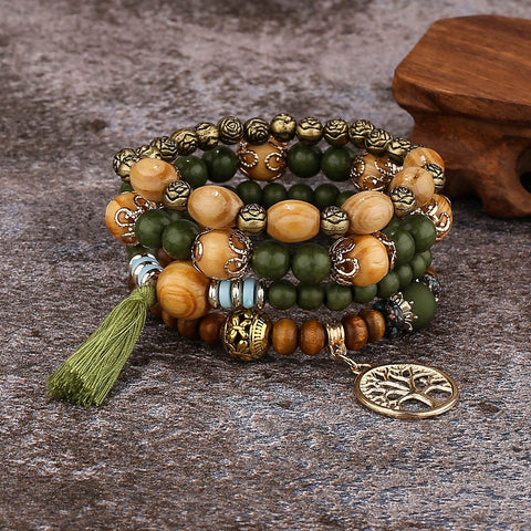 Boho Wooden Stretch Bracelet with polished wooden beads and charm on rustic surface.