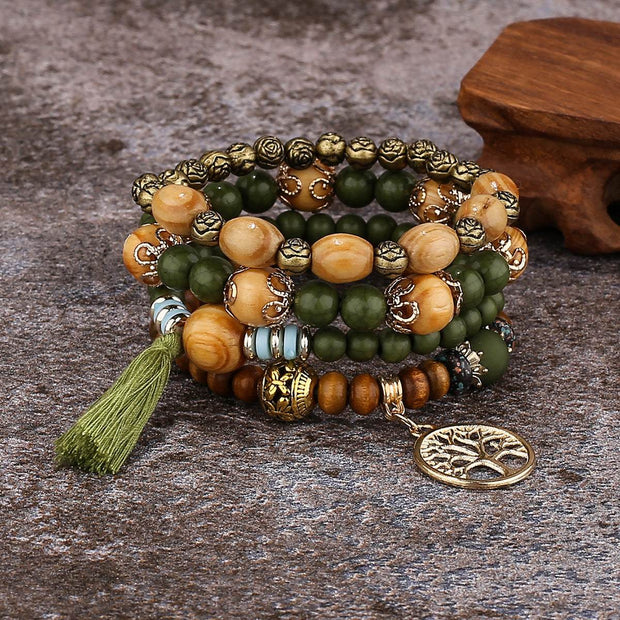 Boho Wooden Stretch Bracelet with polished wooden beads and charm on rustic surface.