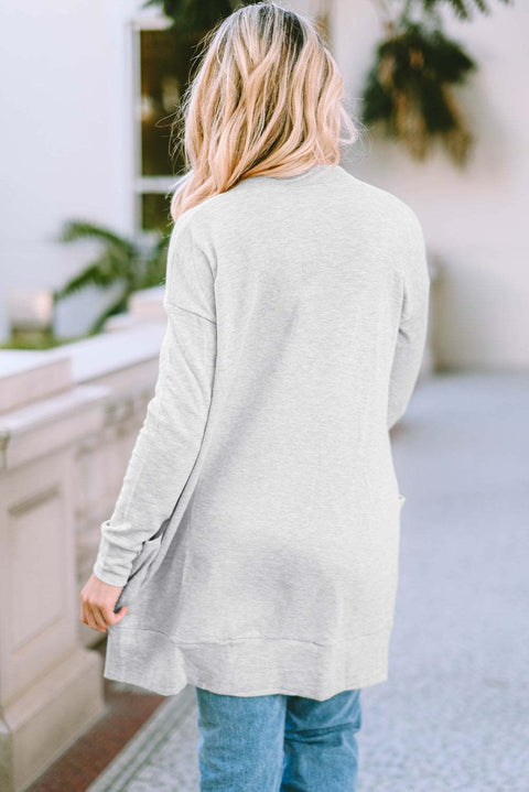 Woman wearing a gray Pocketed Open Front Cardigan outdoors.