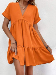 Short-sleeved V-neck dress in orange, featuring a flowy silhouette and elegant design.