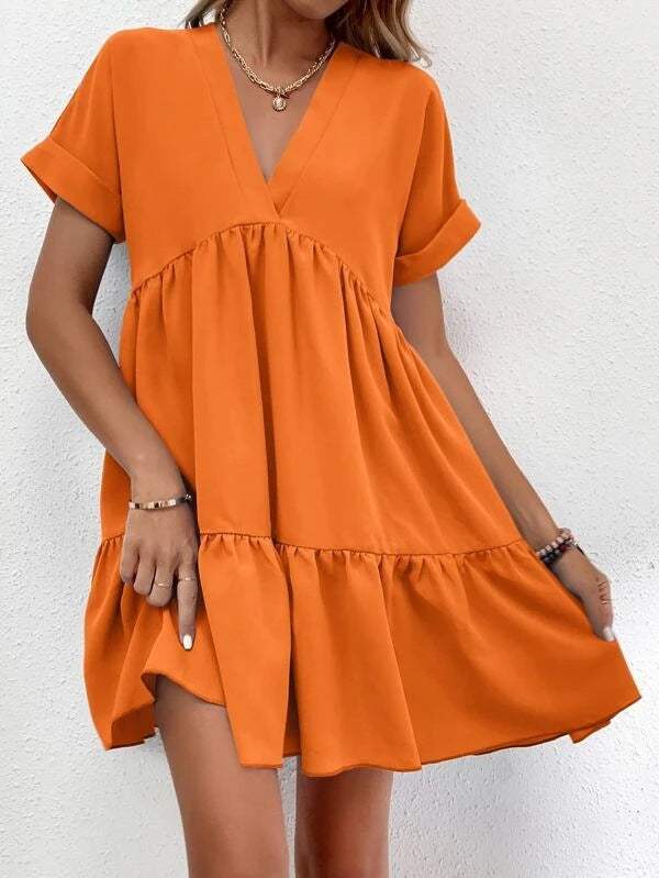 Short-sleeved V-neck dress in orange, featuring a flowy silhouette and elegant design.