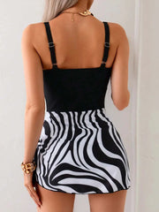 Printed scoop-neck wide-strap one-piece swimwear with black top and zebra print skirt bottom viewed from back