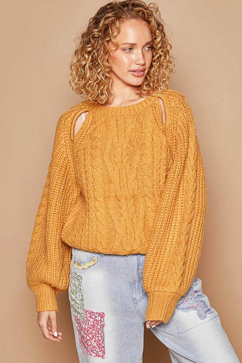 Woman wearing a POL Cable Knit Long Sleeve Sweater in mustard yellow with a cable knit pattern and cutout details.
