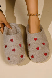 Pink heart embroidered plush slippers for cozy indoor comfort.