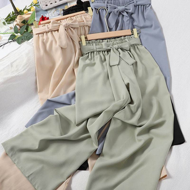 Elastic waist casual pants in assorted colors, featuring wide legs and a bow design.