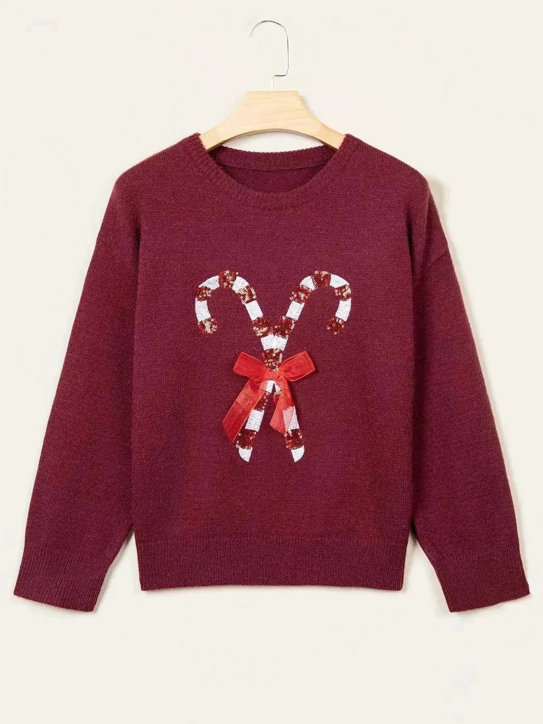 Candy Cane Christmas Sweater in burgundy knit with a red bow and white sequined candy cane design on the front