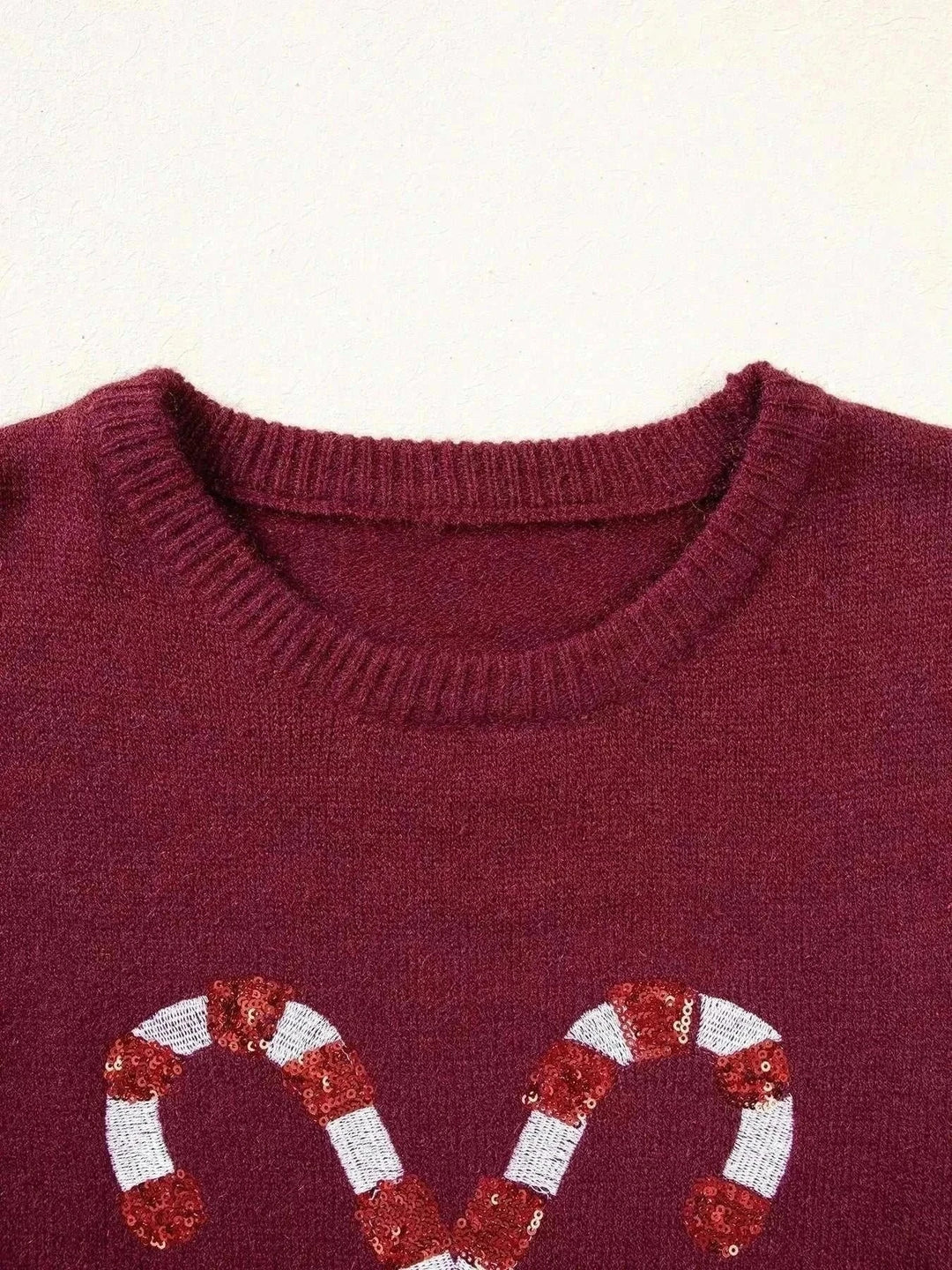 Candy Cane Christmas Sweater in burgundy knit with a crew neckline and two red-and-white sequined candy cane motifs
