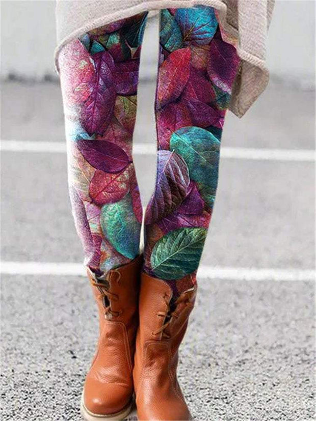 Printed Flared Trousers with colorful leaf pattern and brown boots.