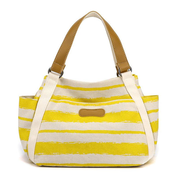 Stylish yellow and white striped One-Shoulder Tote with brown handles, perfect for versatile daily use.