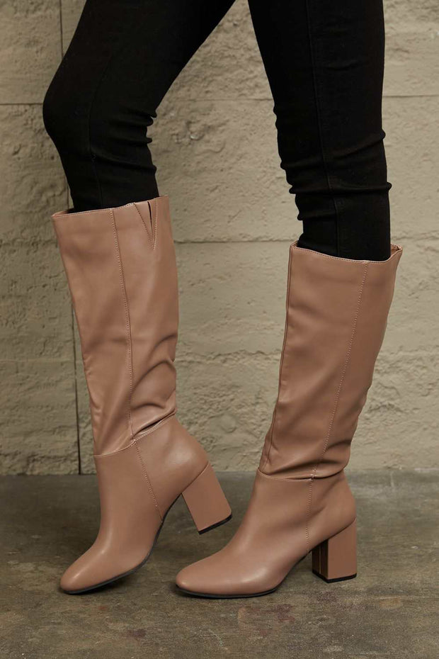 East Lion Knee High Boots with block heel and side zipper closure in beige.