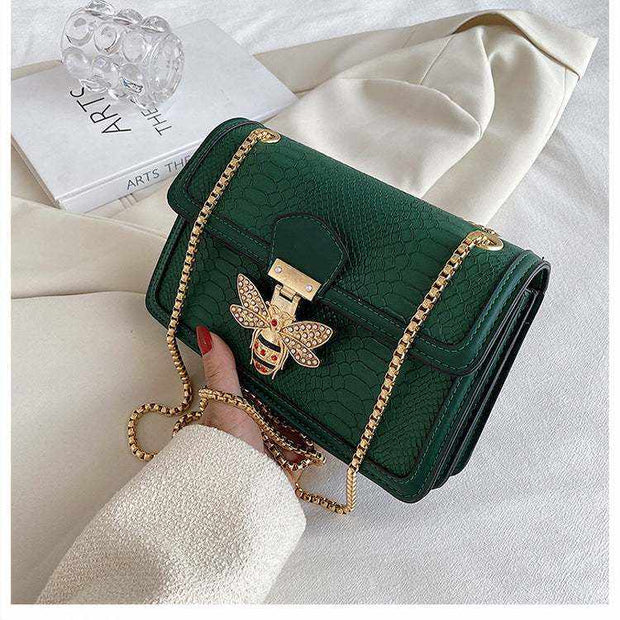 Chain Shoulder Bag in green with gold accents and textured design.