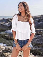 Ruffled Square Neck Half Sleeve Blouse in white on woman outdoors by the beach.