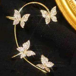 butterfly ear clip with sparkling crystal design on black background