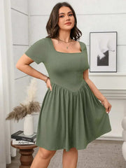 Plus size square-neck short-sleeve mini dress in green, highlighting a flattering fit with a modern neckline for stylish comfort.