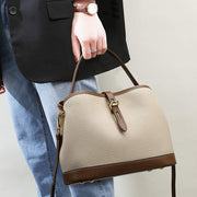 Ladies Messenger Bag with adjustable strap in milky white PU material, featuring sleek bucket design and elegant finishes.