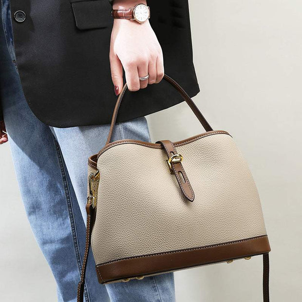 Ladies Messenger Bag with adjustable strap in milky white PU material, featuring sleek bucket design and elegant finishes.