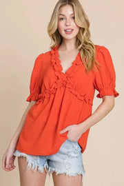Lime N Chili Ruffled Puff Sleeve Babydoll Top in vibrant orange with deep V-neckline and ruffled accents.