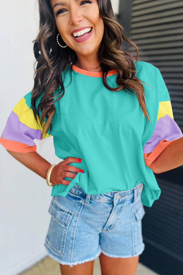 Green Color Block Oversize Top with round neckline and color block sleeves in shades of green, purple, and orange.