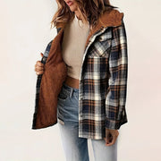 woman wearing plaid hooded fleece-lined jacket with brown fleece interior and blue jeans
