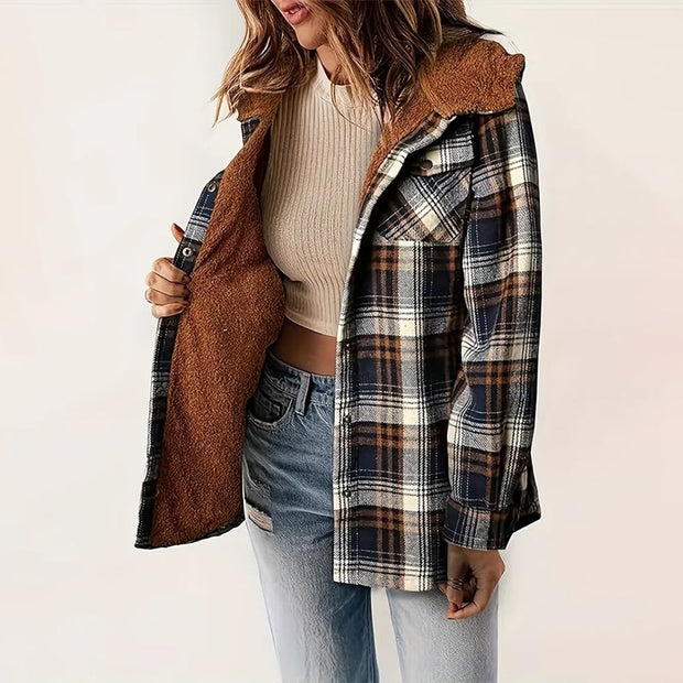 woman wearing plaid hooded fleece-lined jacket with brown fleece interior and blue jeans