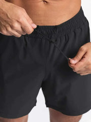 Men's black elastic waist active shorts for workouts and sports.