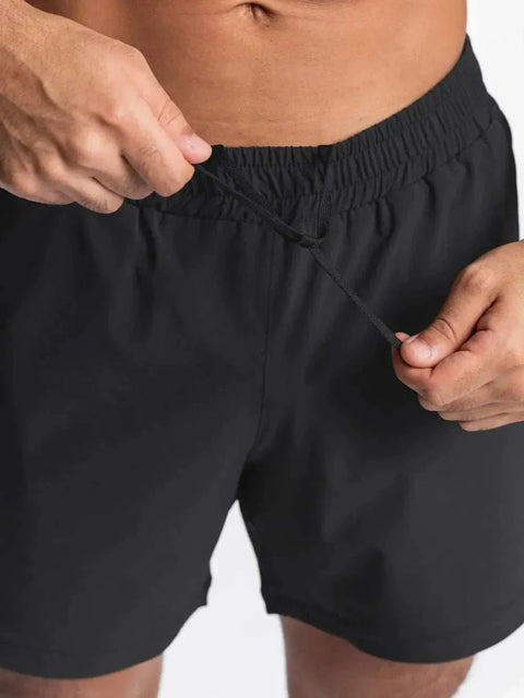 Men's black elastic waist active shorts for workouts and sports.