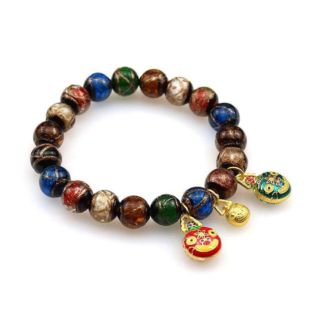 Gray Colored Glaze Bracelet with glossy geometric beads and charm accents.
