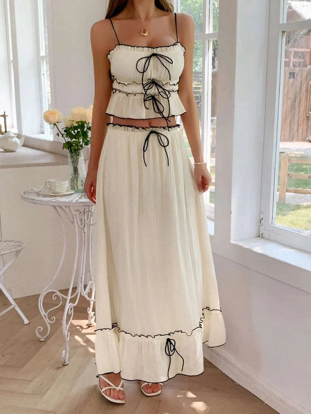 Frill Square Neck Cami and Skirt Set in white with black trim, featuring a square neckline and delicate frills, posed in a bright, airy room.