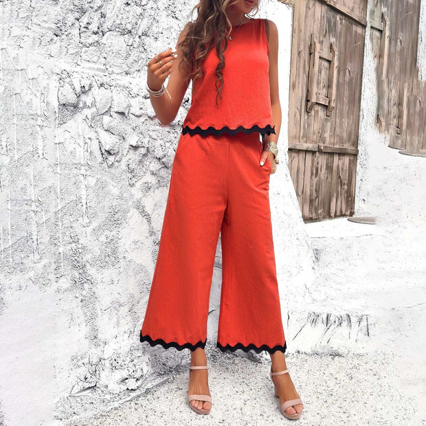 Vibrant orange two-piece summer wave print suit with scalloped edges, perfect for beach outings or casual events.